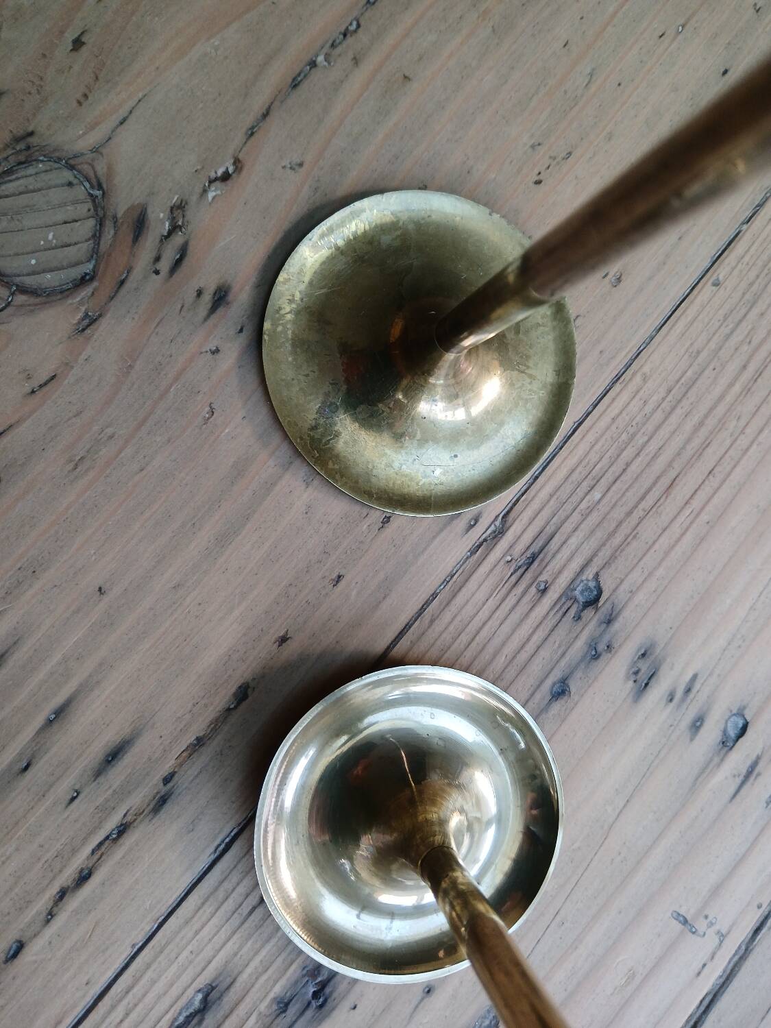 Set of two straight brass candlesticks.