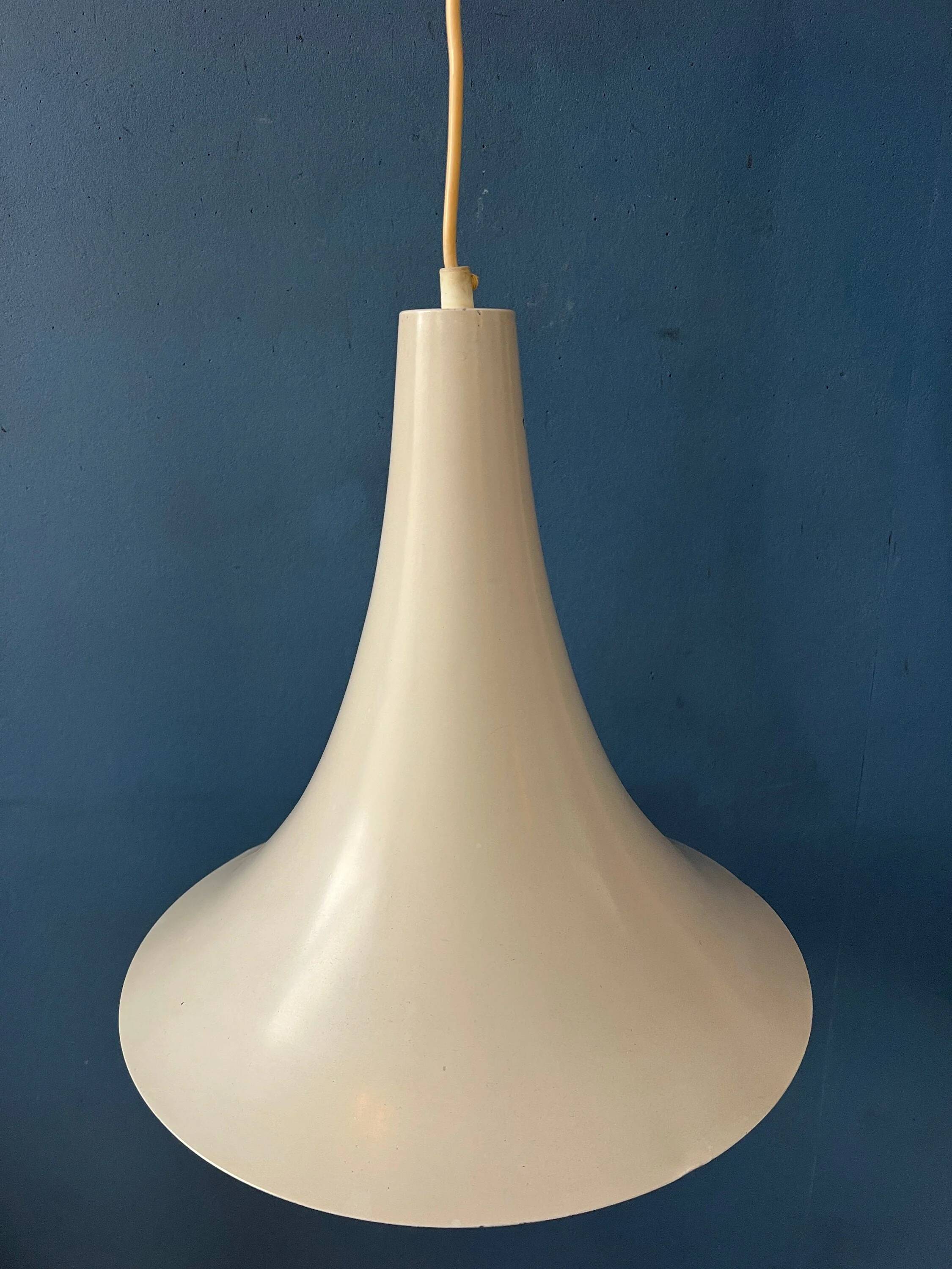 Small vintage beige pendant light in the shape of a witch's hat.