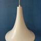 Small vintage beige pendant light in the shape of a witch's hat.