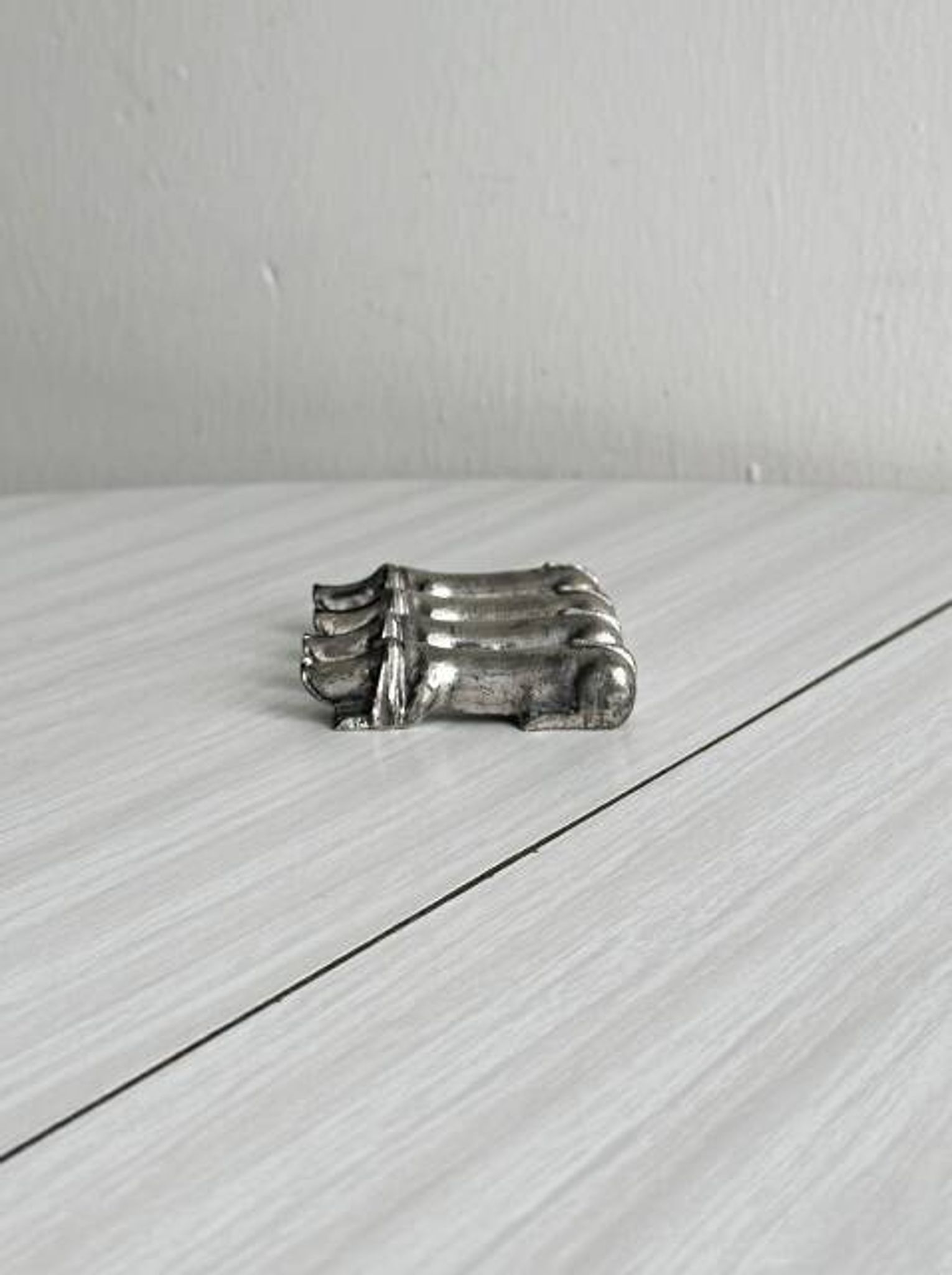Antique metal knife rest in the shape of a dog.