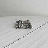 Antique metal knife rest in the shape of a dog.