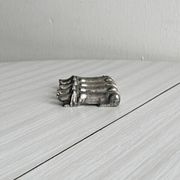 Antique metal knife rest in the shape of a dog.