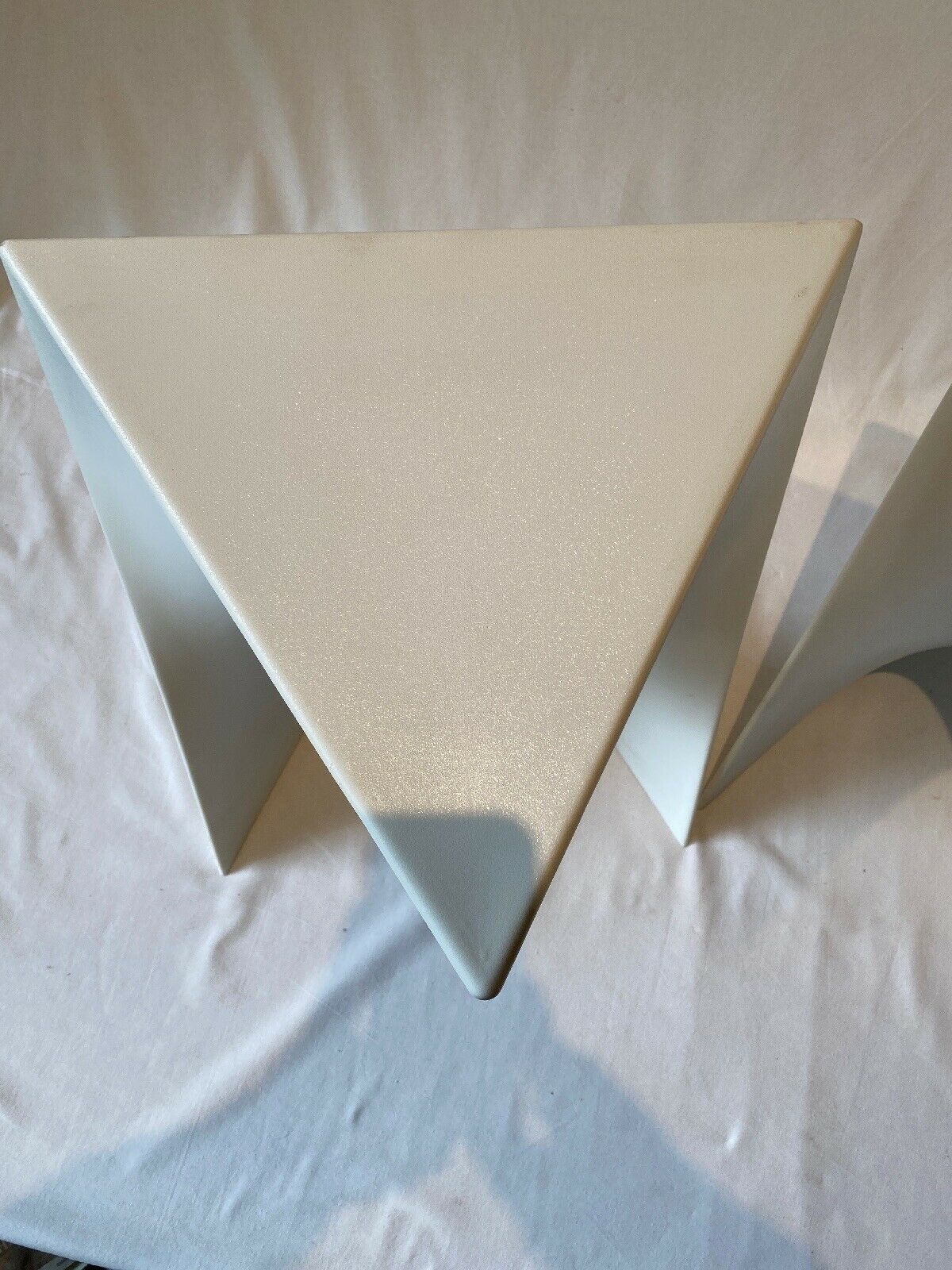 Pair of unmarked triangular white design stools