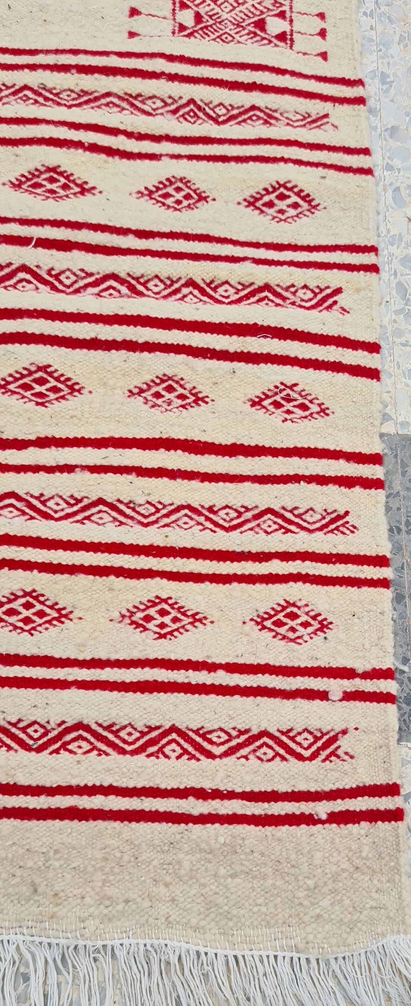Traditional ethnic-patterned red and white carpet