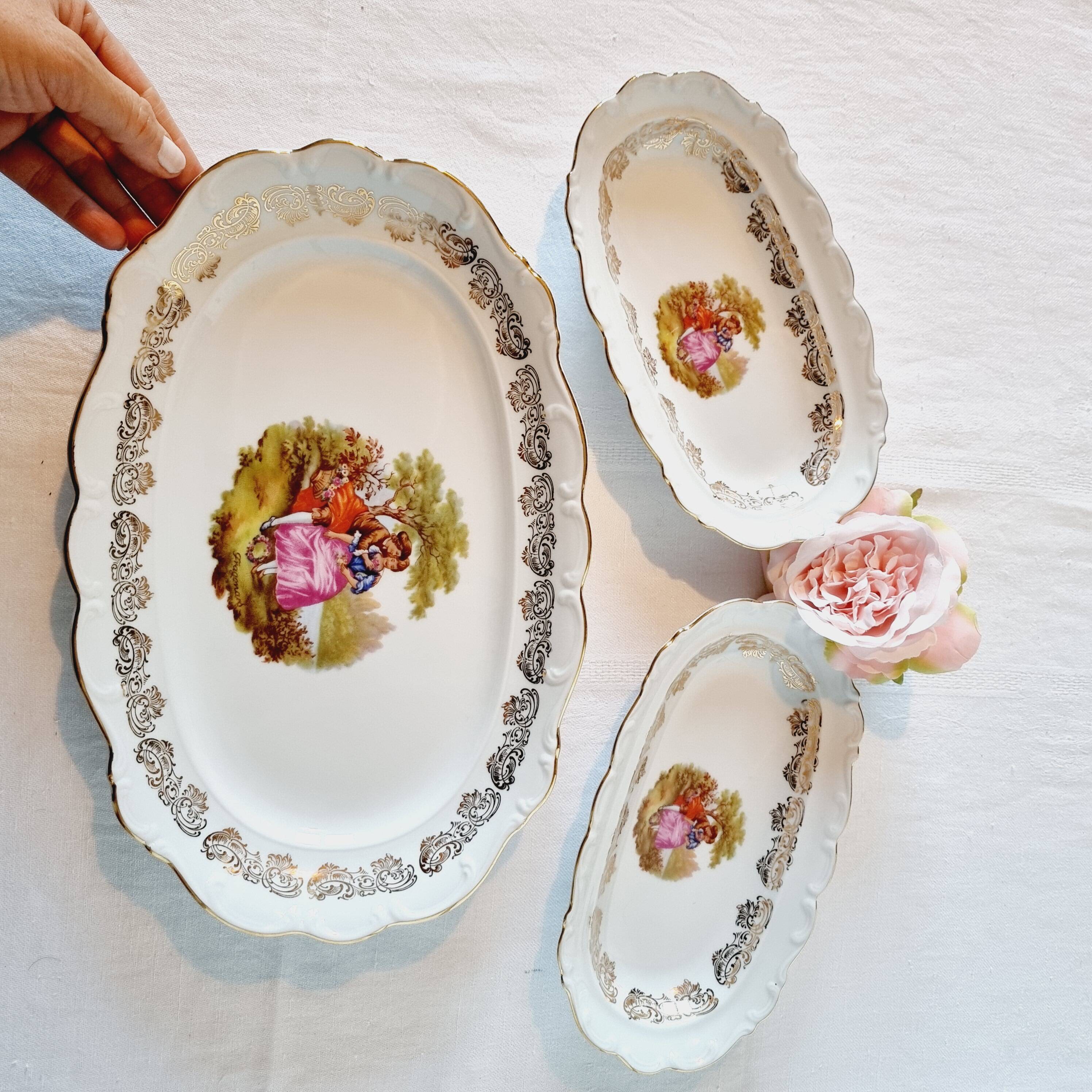 3 serving dishes with frangonard romantic scene with designs and borders in 24 carat gold.