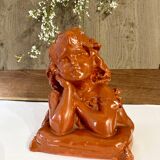 Bust of a pensive child in plaster