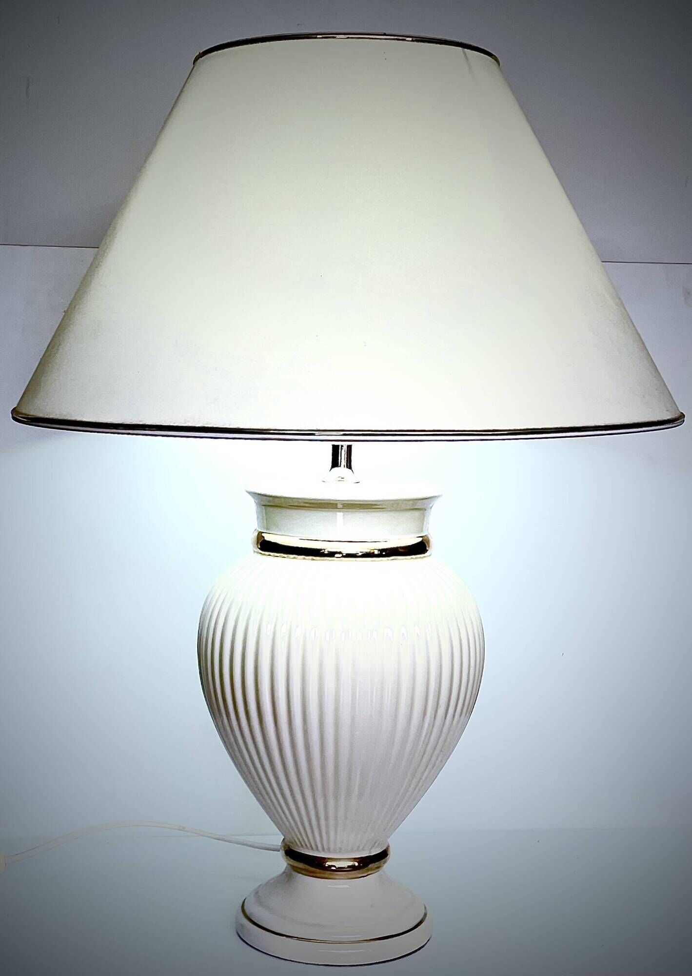 Vintage white ceramic table lamp, ribbed body and conical shade.