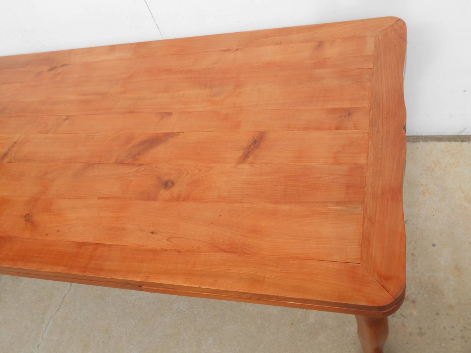 Large solid wood table with integrated extensions.