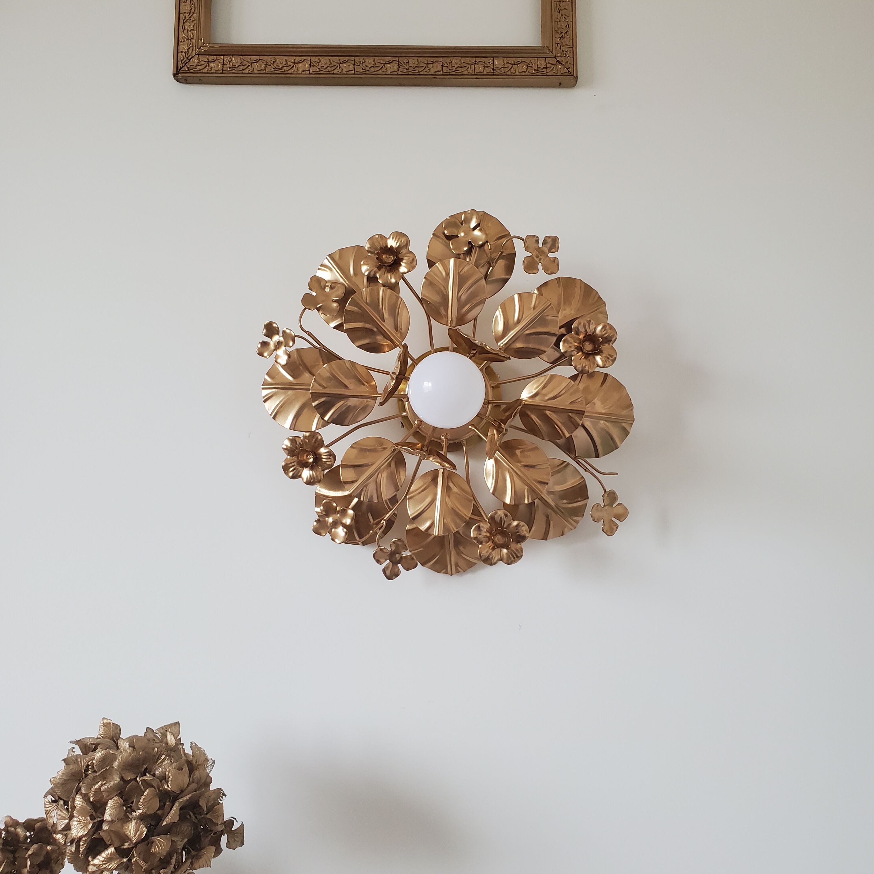 Golden metal flower sconces