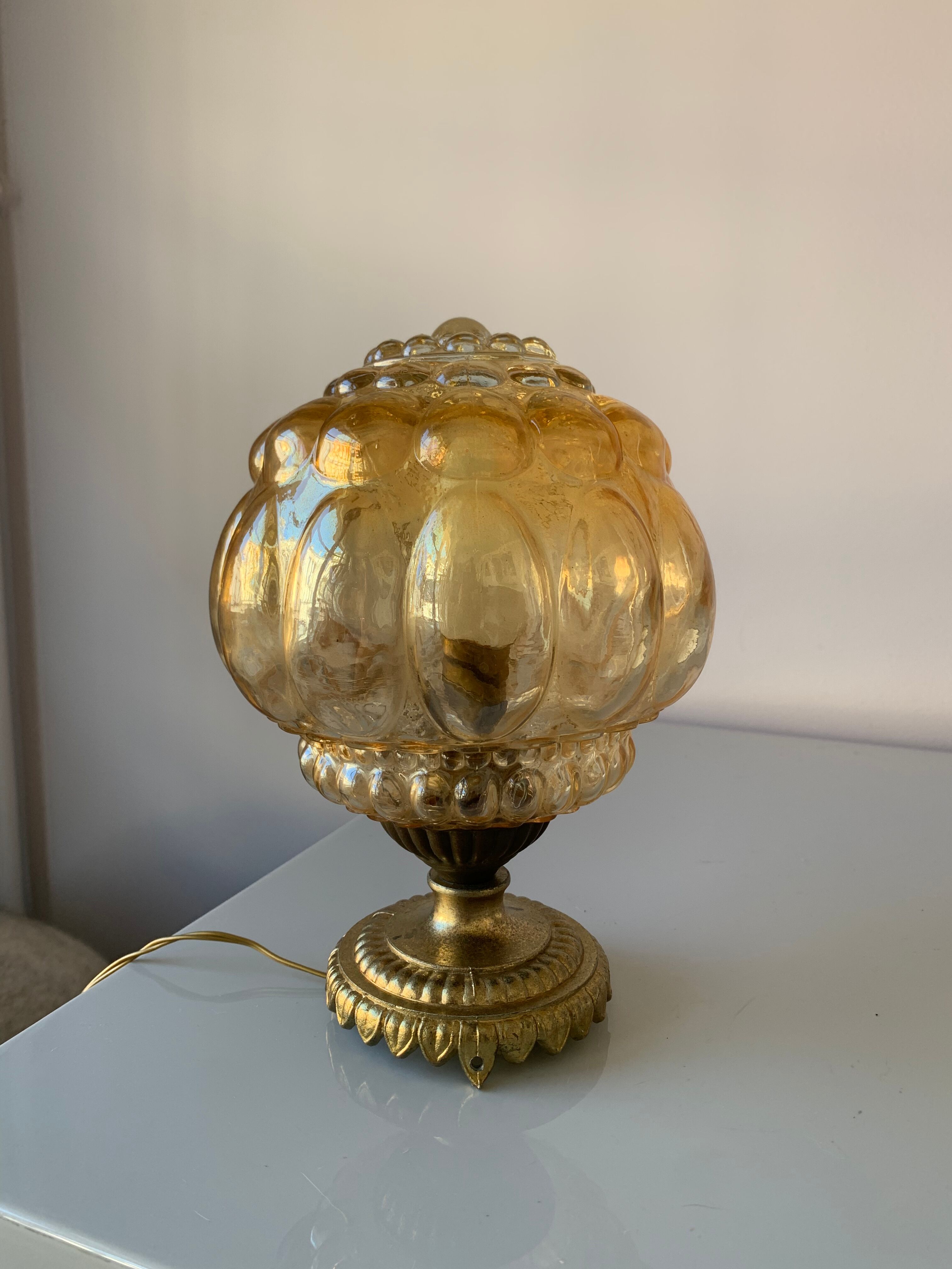 Old vintage table lamp made of amber molded glass
