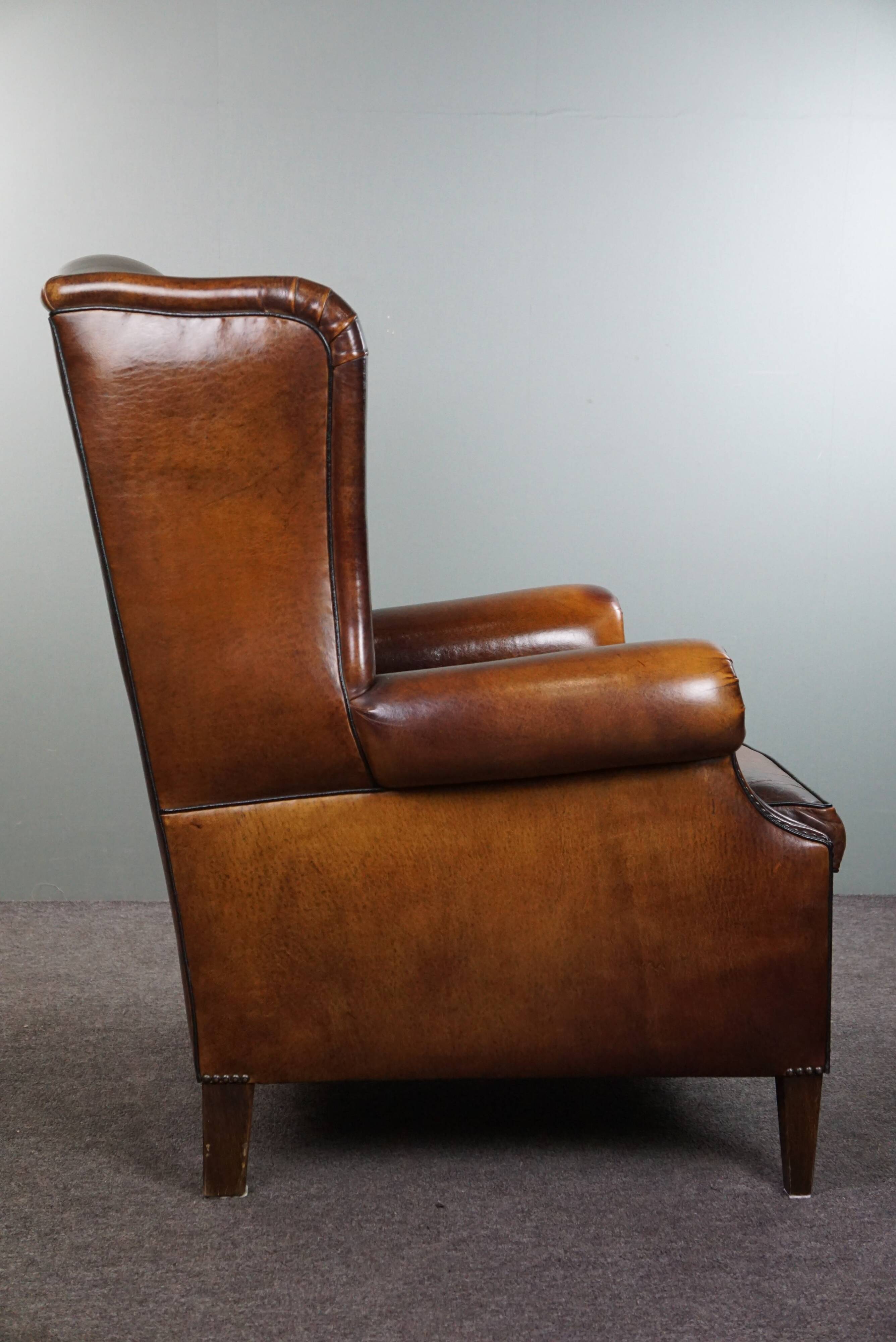 Luxurious large sheep leather wingback armchair with beautiful colors and amazing patina