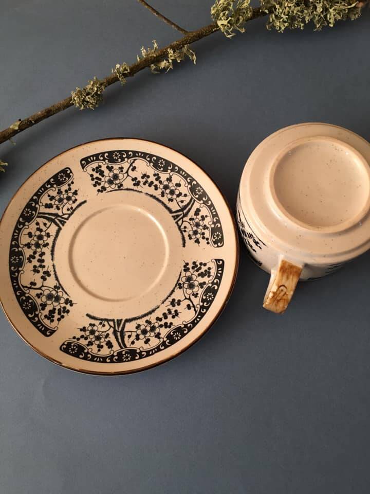 Large stoneware cup and saucer with delicate floral patterns