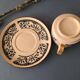 Large stoneware cup and saucer with delicate floral patterns