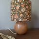Table lamp with a wooden ball base, floral print in bohemian style.