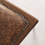 Art Deco style chair in carved wood and leather.