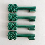 4 green ceramic knife rests in vintage key shape