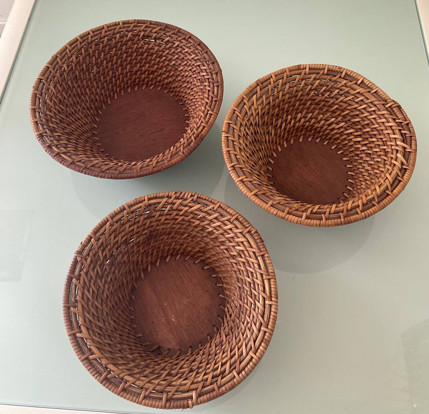 Trio of vintage woven rattan and wicker baskets
