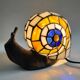 Tiffany-style lamp in the shape of a snail.