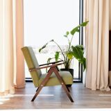 Vintage armchair in moss green bouclé design by H. Lis.