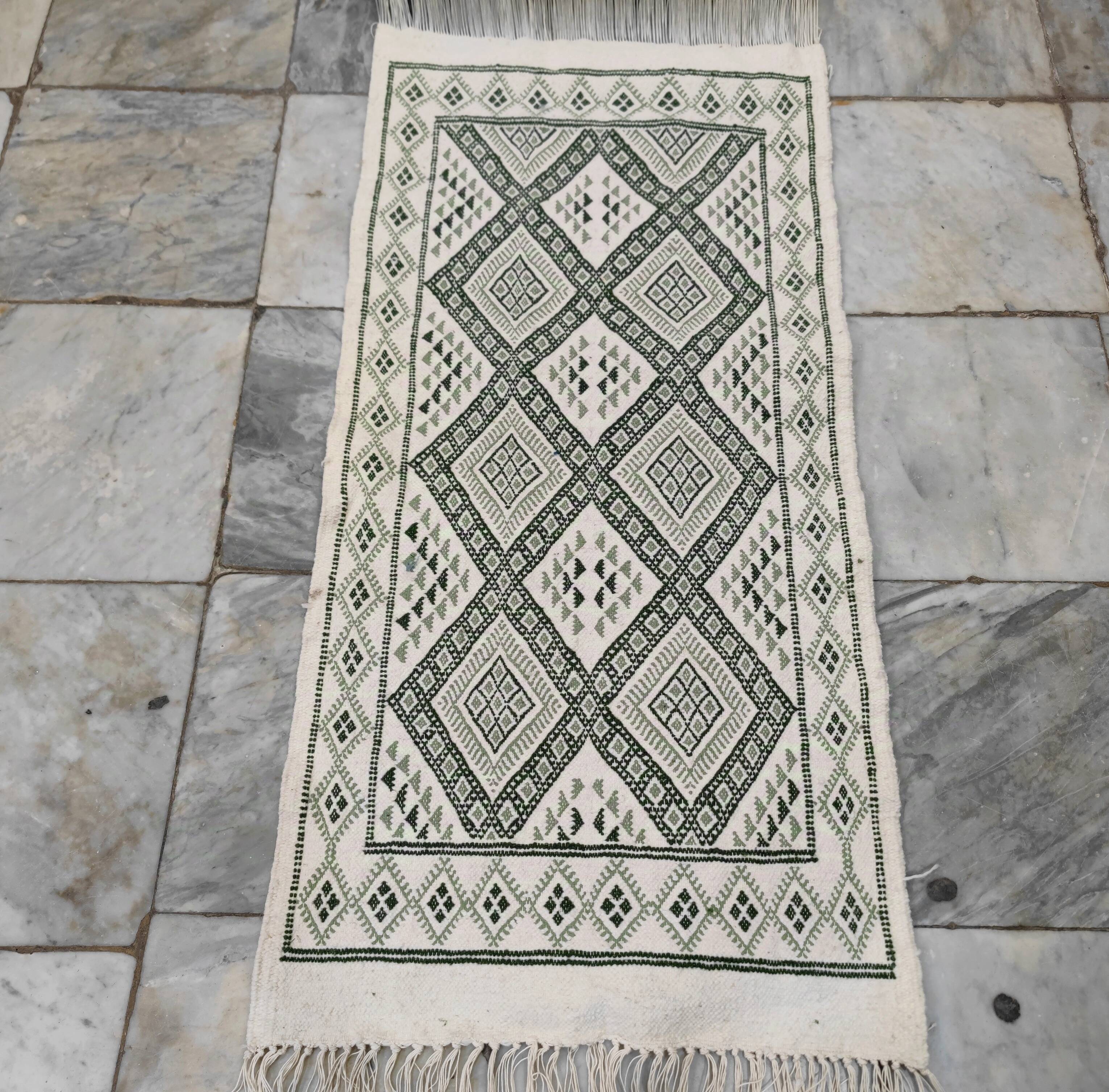 Handwoven white and green rug
