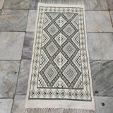 Handwoven white and green rug