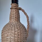 Old high wicker glass bottle
