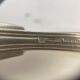 Set of 7 silver-plated dessert spoons with a bi-lobed filet pattern.