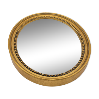 Small old oval mirror in gilded wood