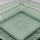Square sculptural glass plate, textured wavy finish.
