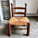 Brutalist low chair in dark wood and straw no. 2