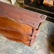 Curved and turned wooden wall shelf