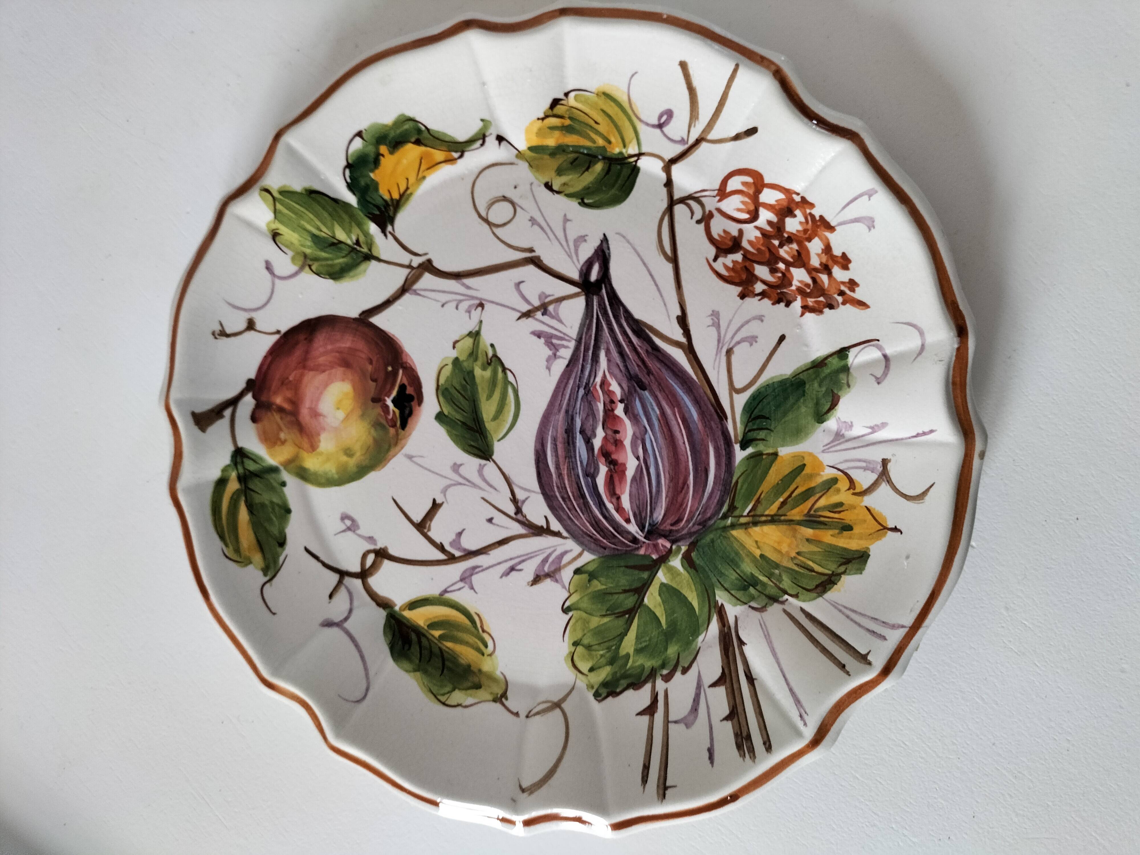 Set of three earthenware plates from Bassano, hand-painted with fruit and flower designs.