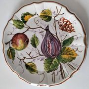 Set of three earthenware plates from Bassano, hand-painted with fruit and flower designs.