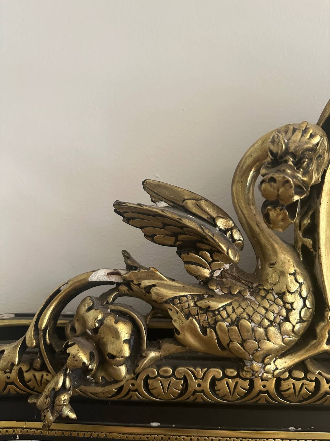 Napoleon III mirror with a pediment featuring black and gold dragons and birds.