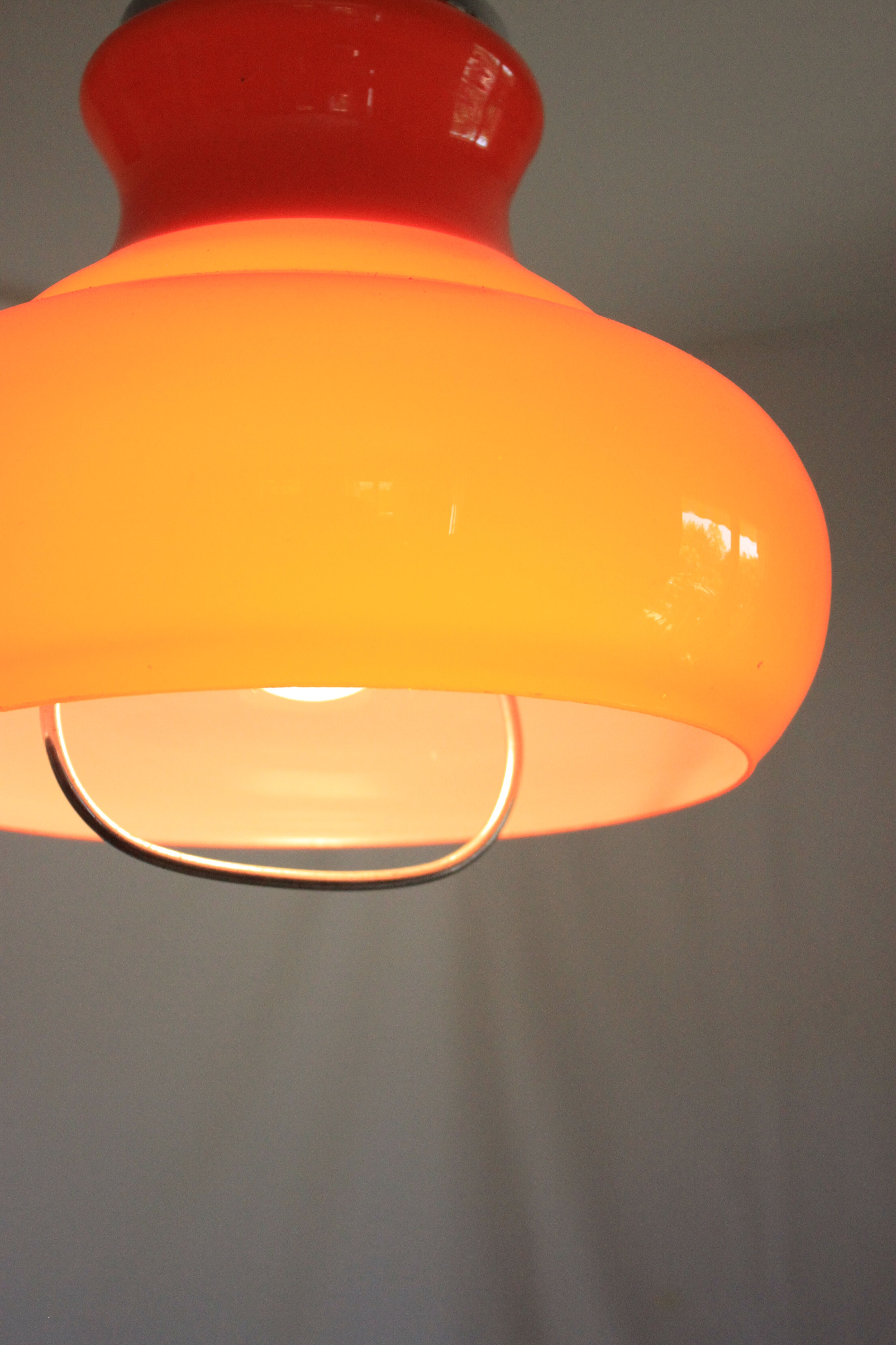 Suspension goes up and down from the kitchen, orange blown glass.