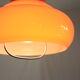 Suspension goes up and down from the kitchen, orange blown glass.