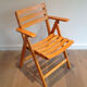 Paire de fauteuils pliants en bois vernis signé Clairitex