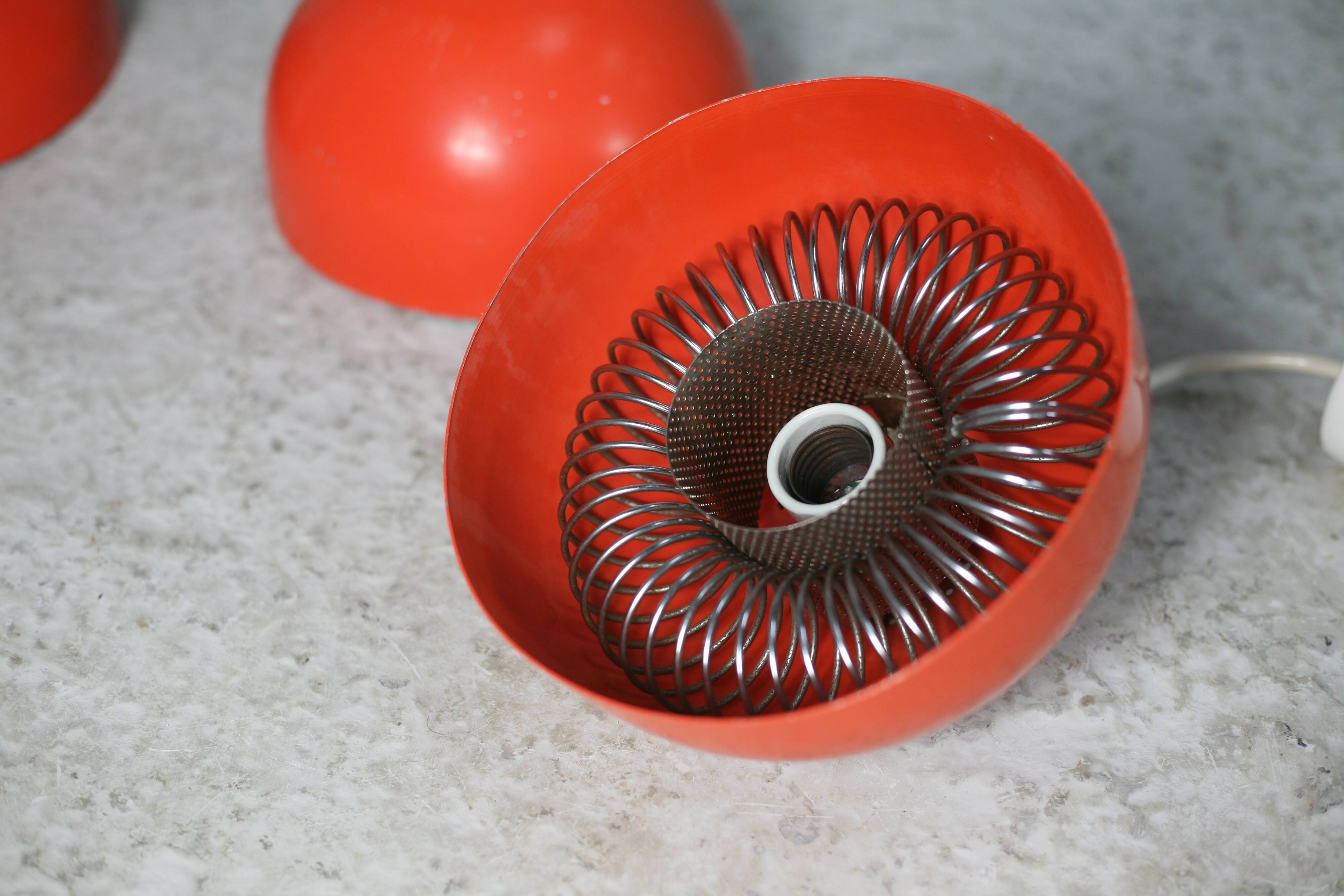 Set of 4 "spring" hanging lamps, orange steel, France, circa 1970