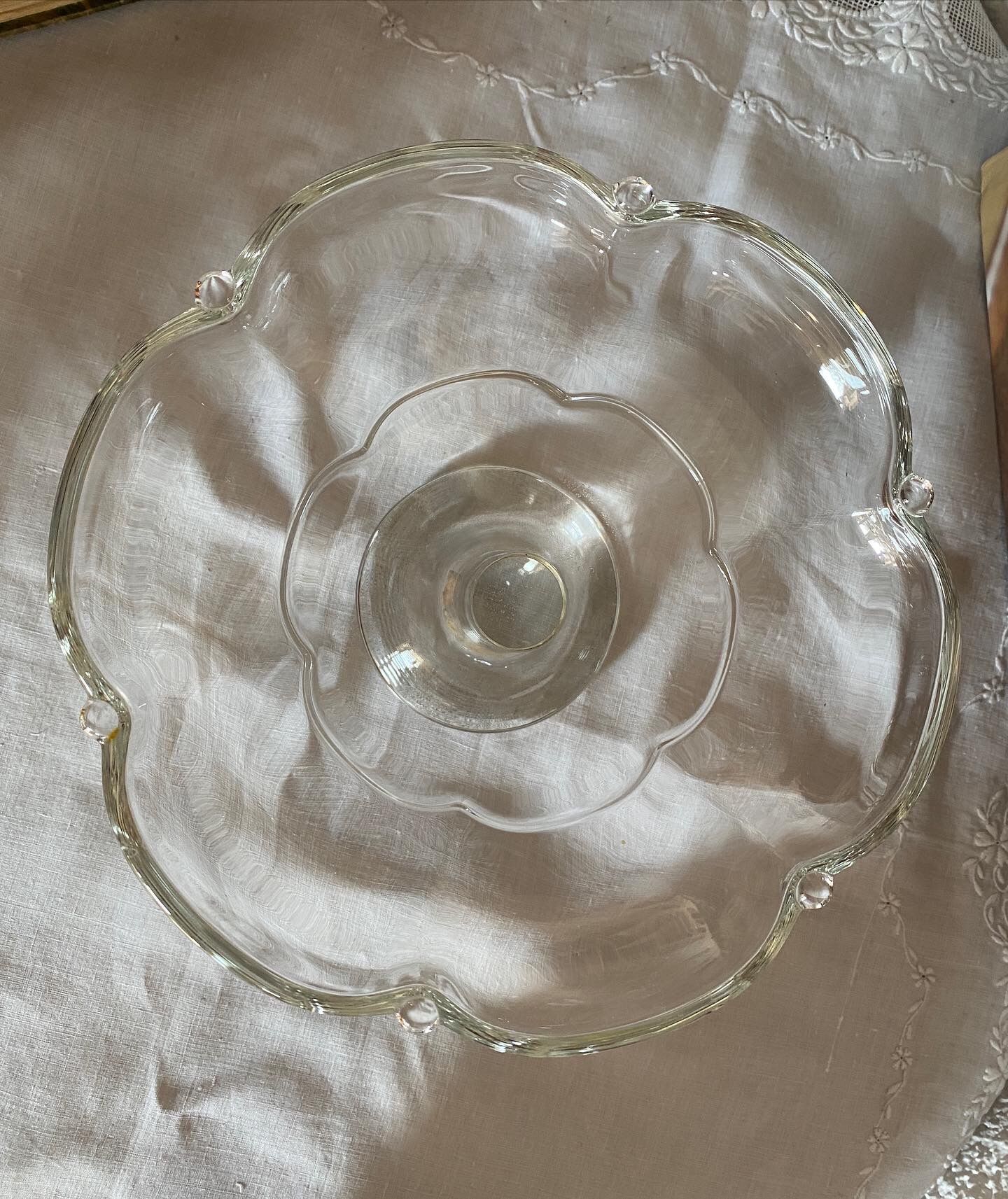 Standing molded glass cup depicting a flower