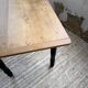 Oak farmhouse table with turned black legs.