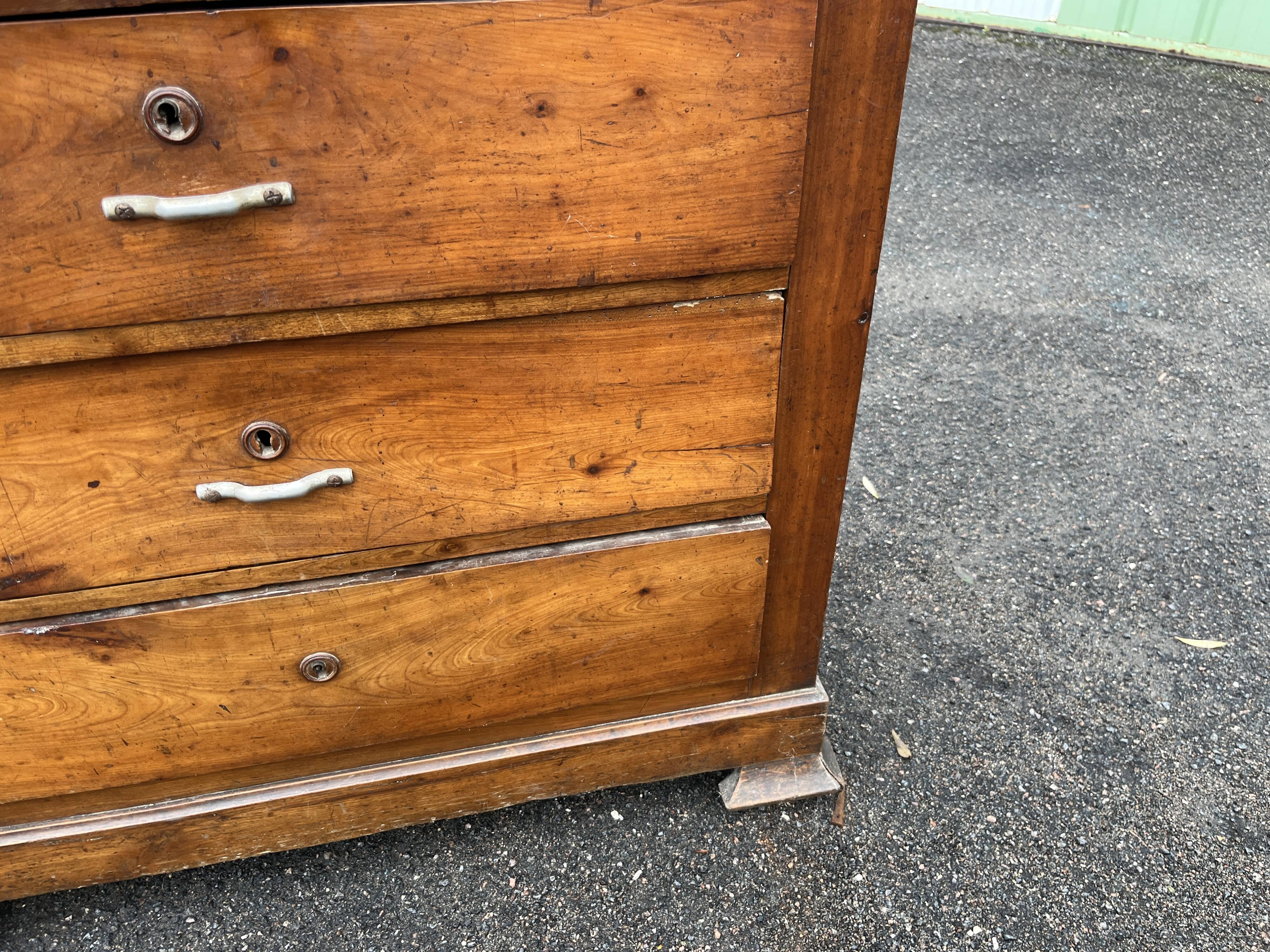 Antique 19th-century wooden chest of drawers with a marble top