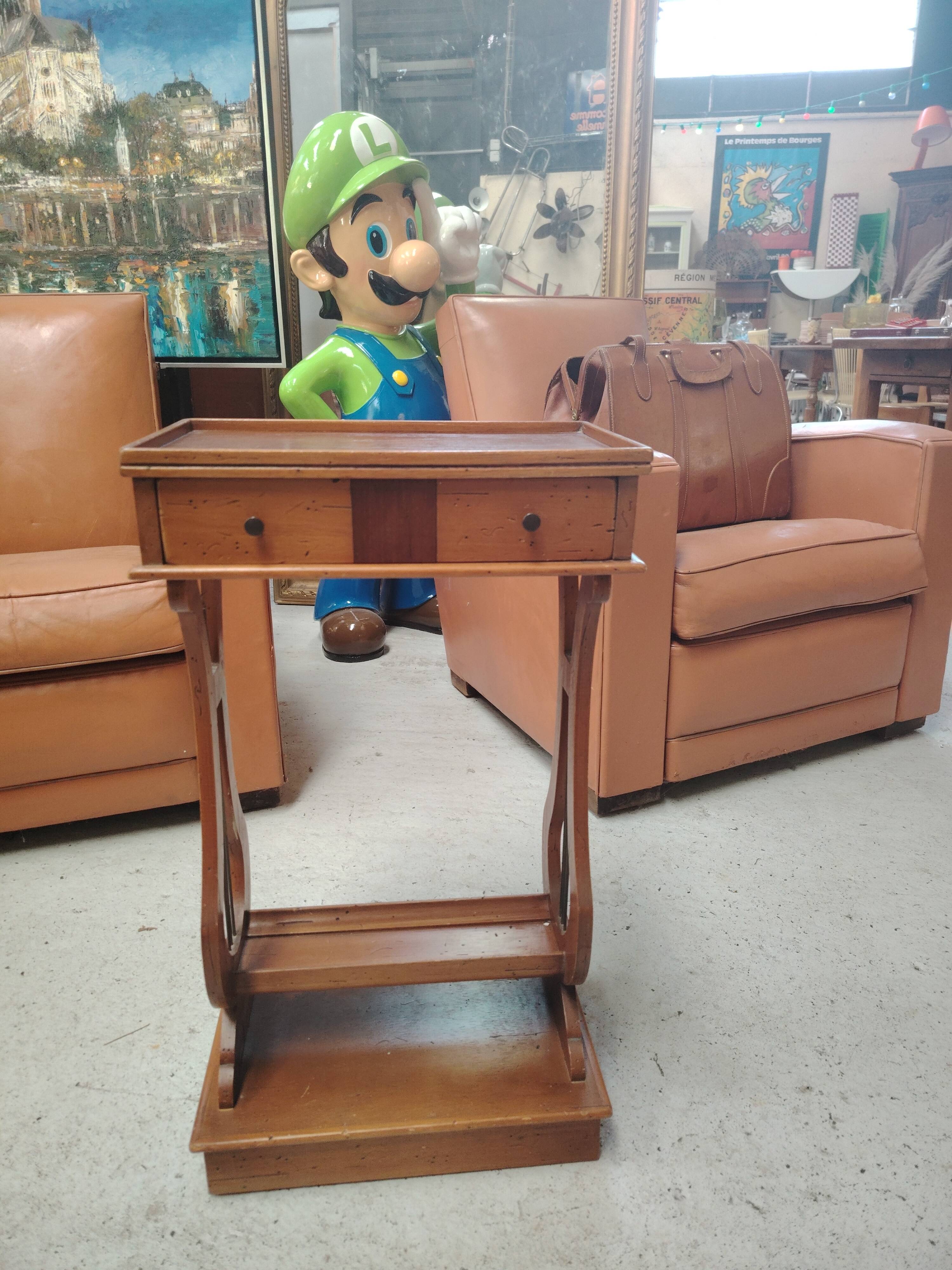 Vintage end table with lyre legs and two drawers.