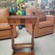 Vintage end table with lyre legs and two drawers.