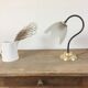 Table lamp with glass globe and brass foot