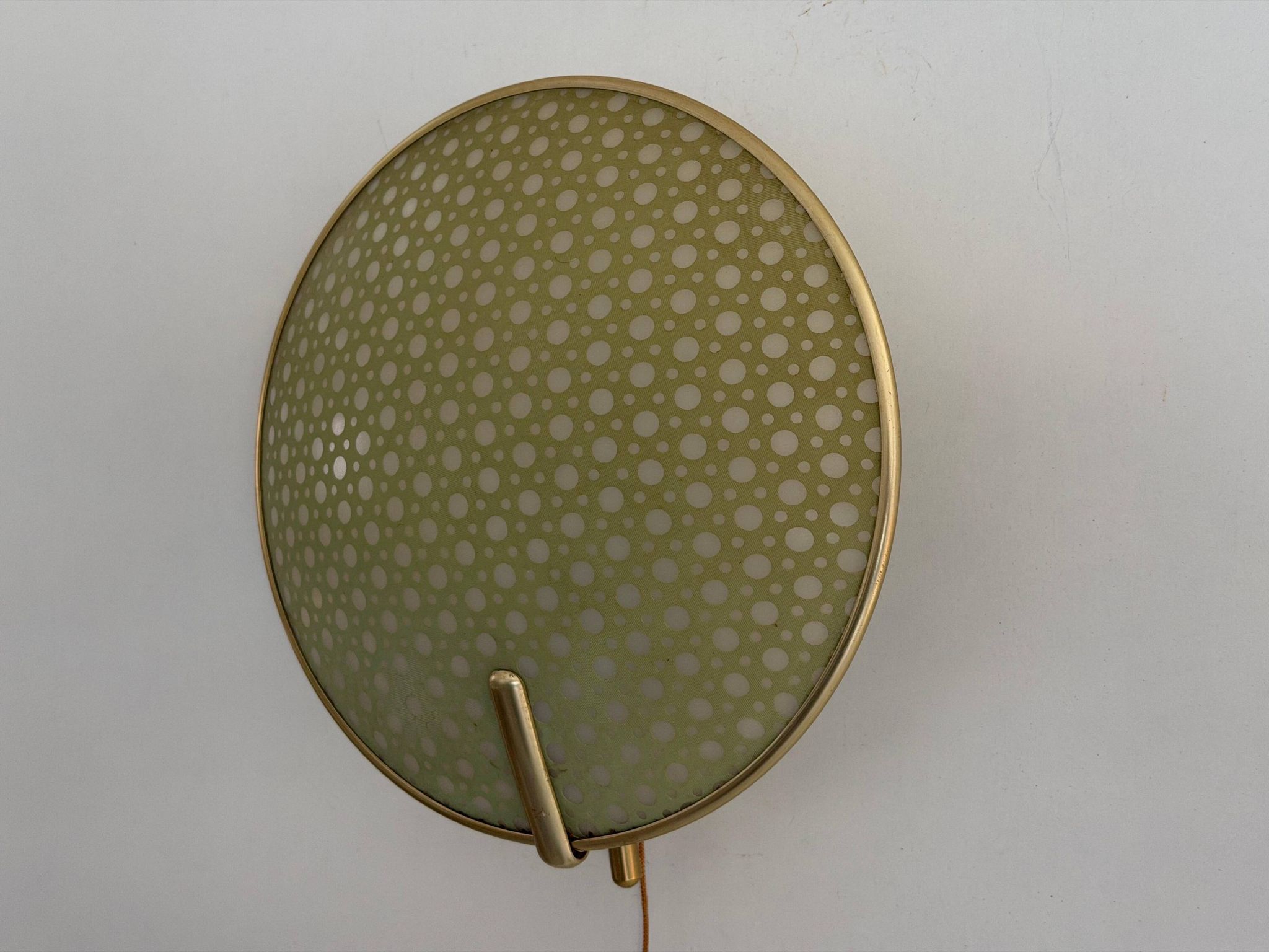 Pair of green plexiglass and gold metal wall lights by Erco, 1950s, Germany.