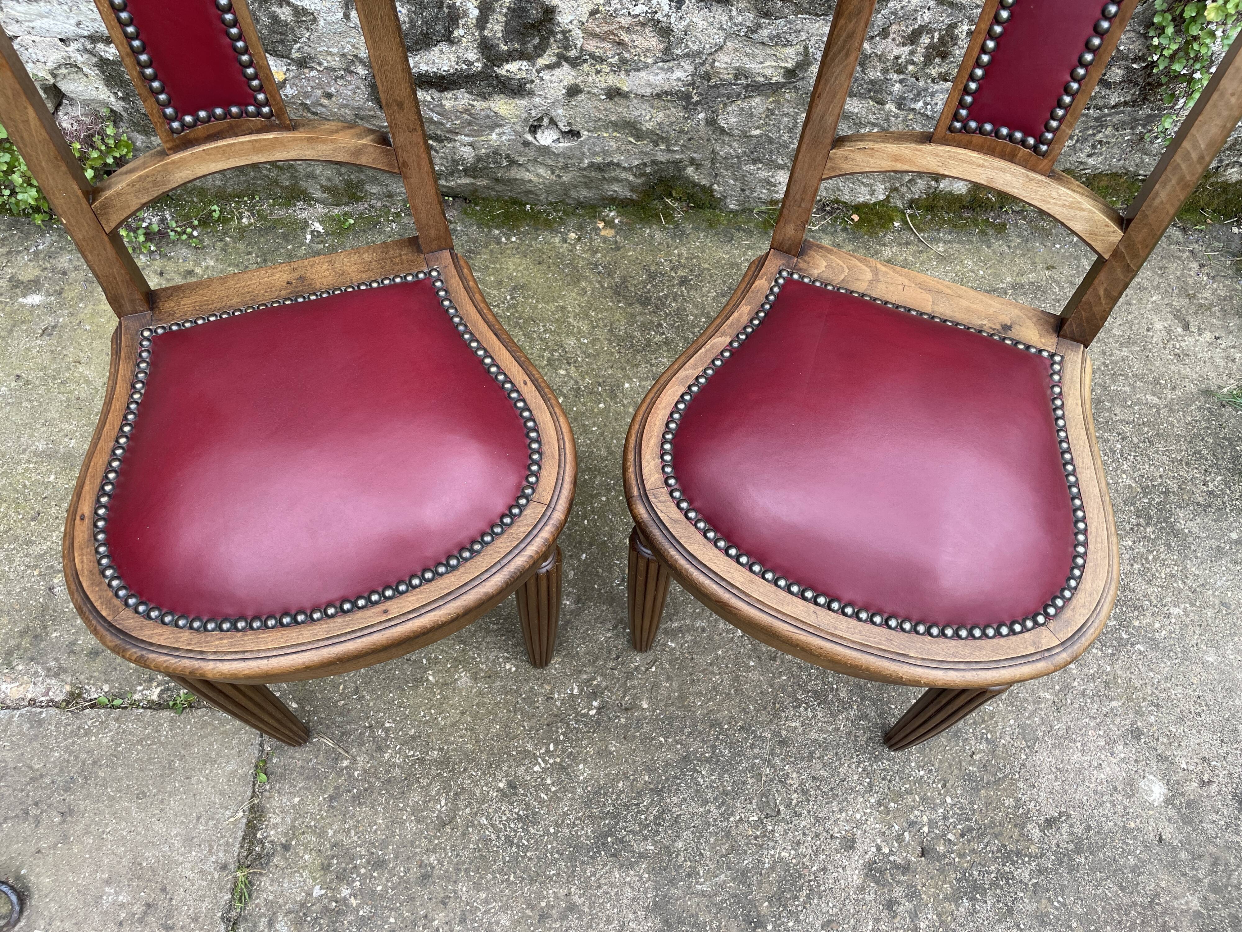 Pair of studded burgundy leather Art Deco chairs