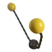 Twisted wrought iron wall bracket with wooden balls.