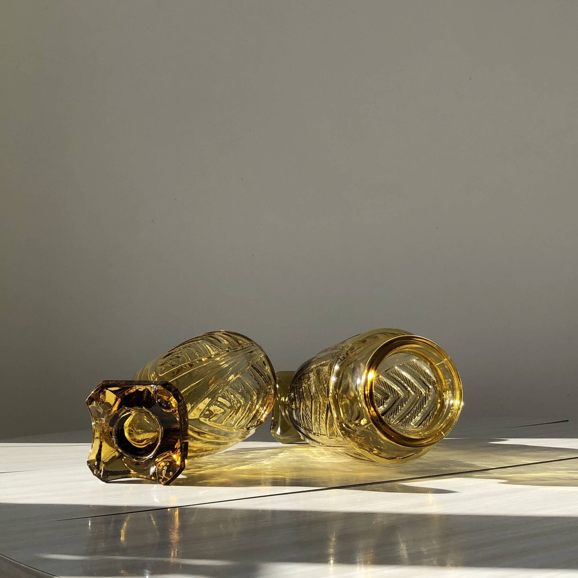 Duo of art deco vases in yellow glass with scroll patterns