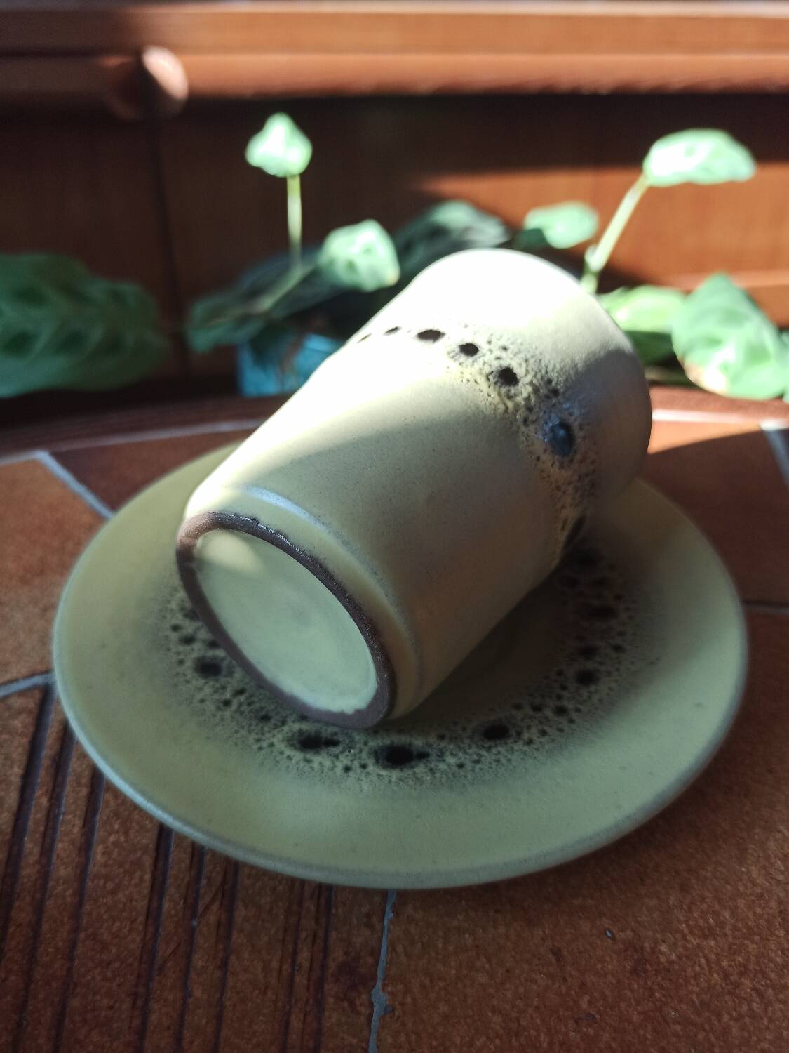 A pair of vintage glazed stoneware cups and saucers.