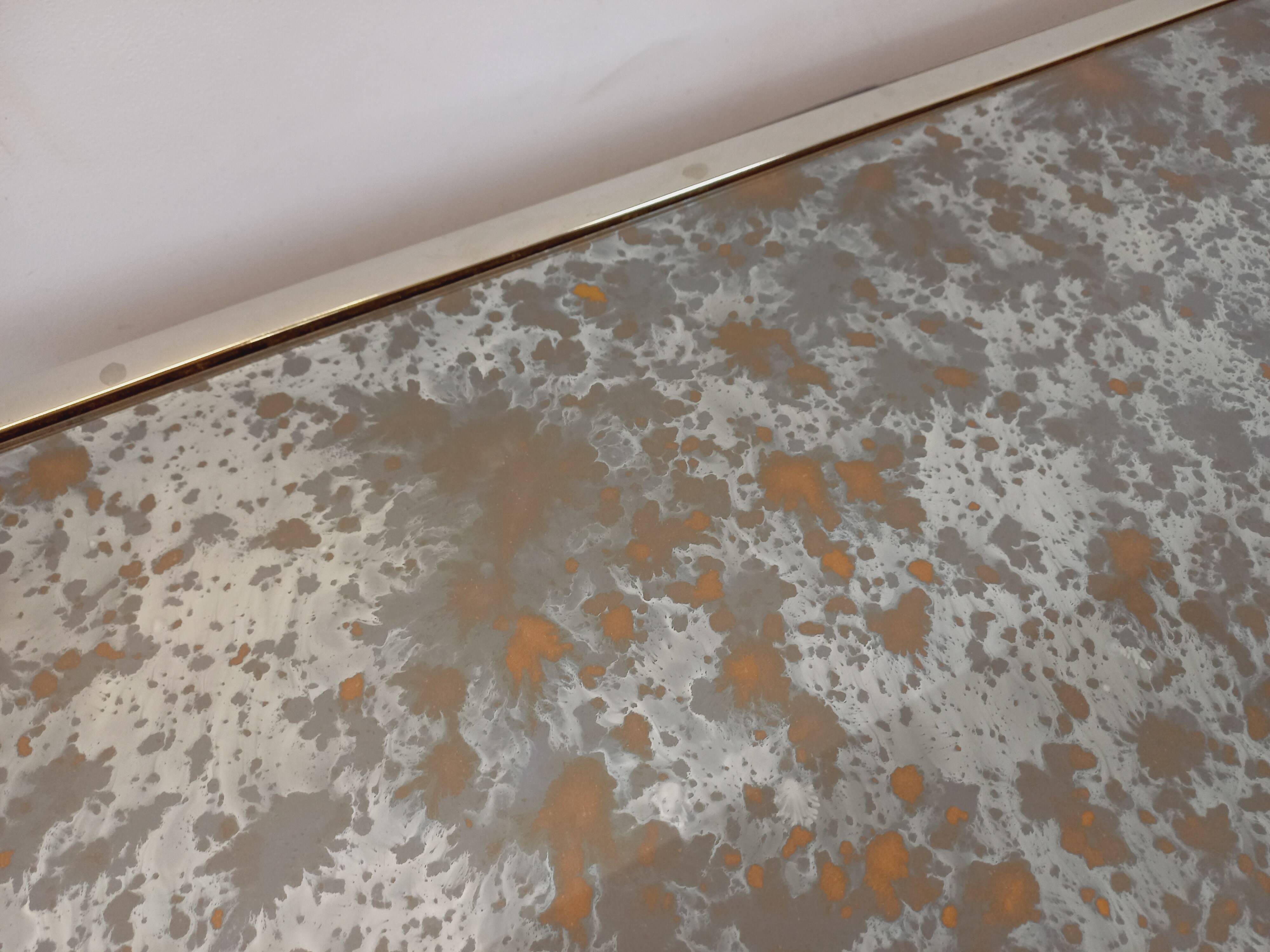 Vintage coffee table in églomisé glass, chrome and leather from the 70s